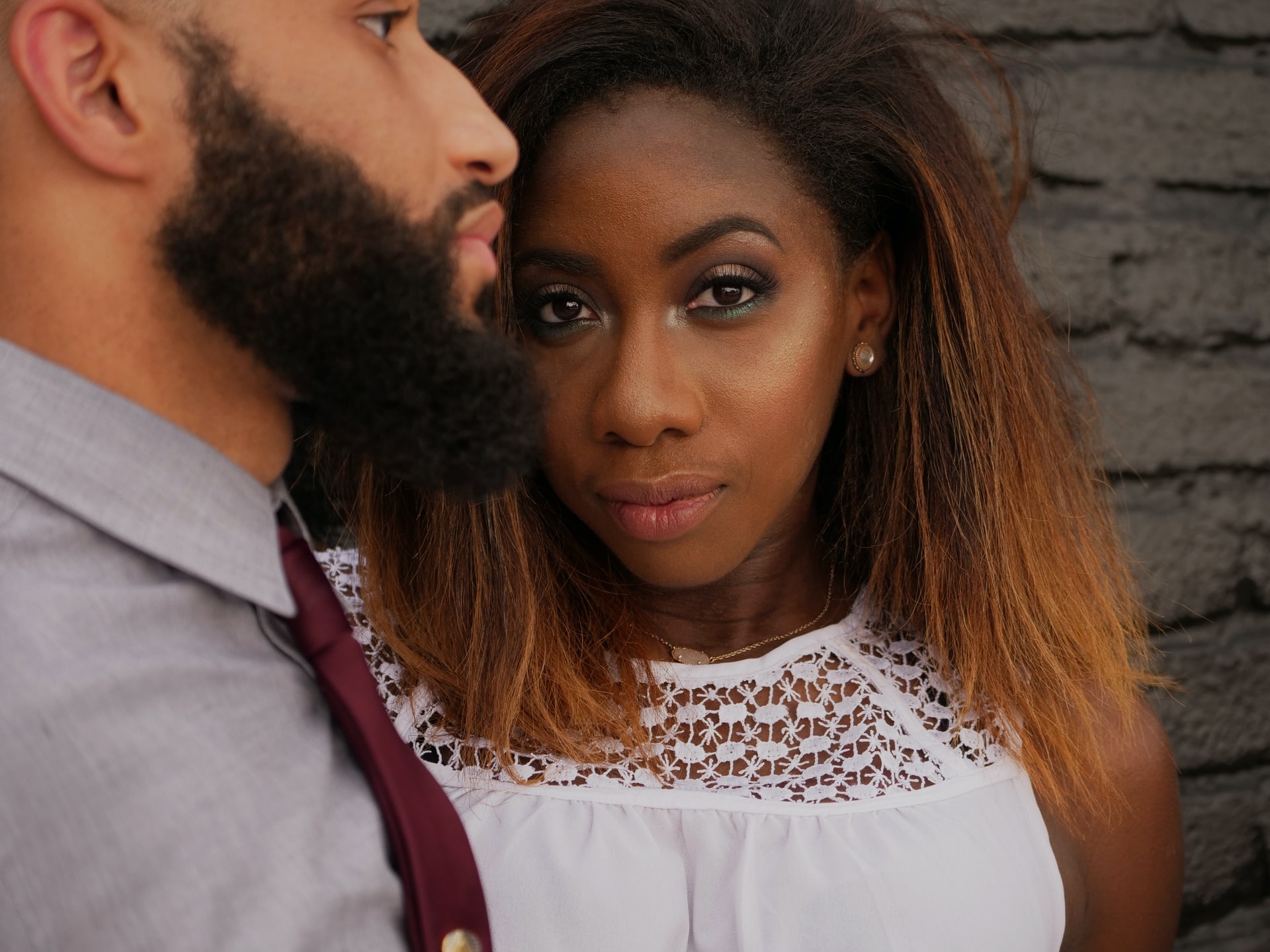 black woman wearing white shirt beside man