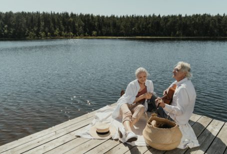 senior man and woman sitting on wooden dock