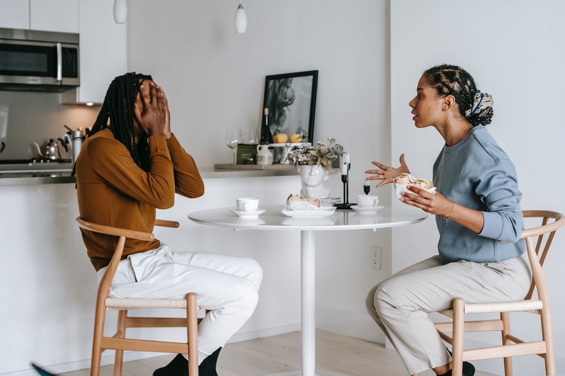 a couple quarreling at table