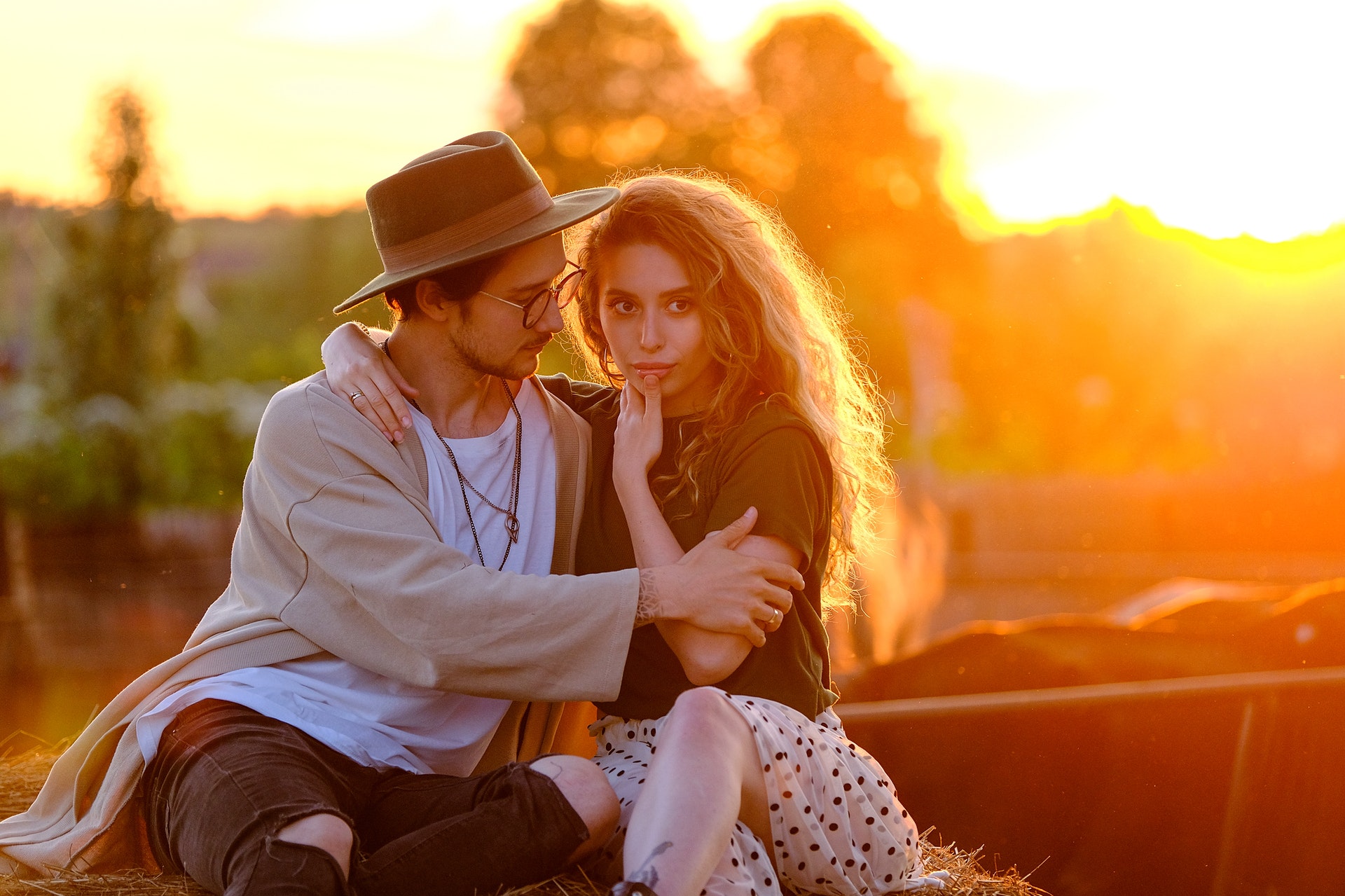 young couple embracing on roof in a countryside