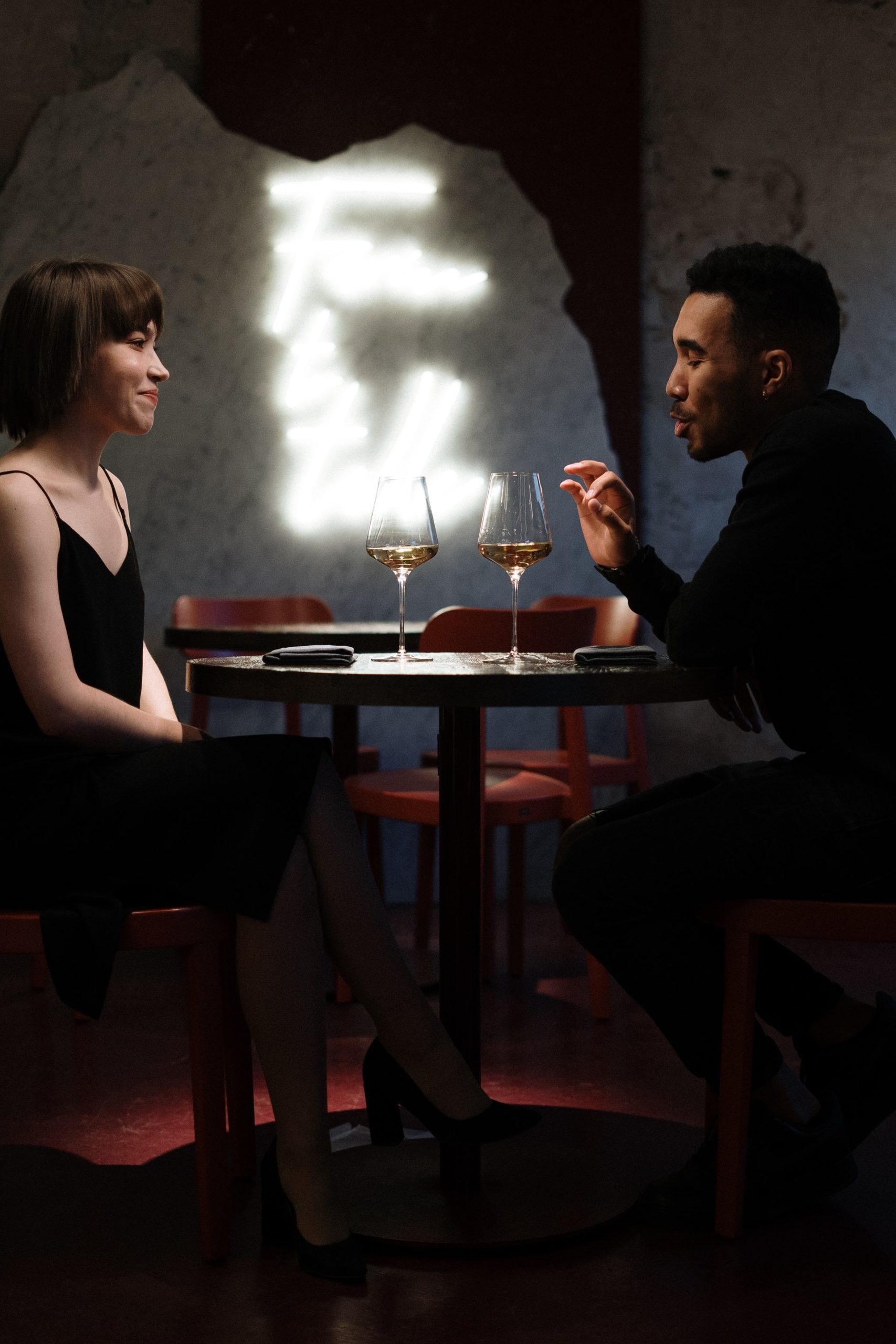 man and woman siting on chair in front of table