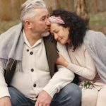 happy senior couple hugging in autumn park
