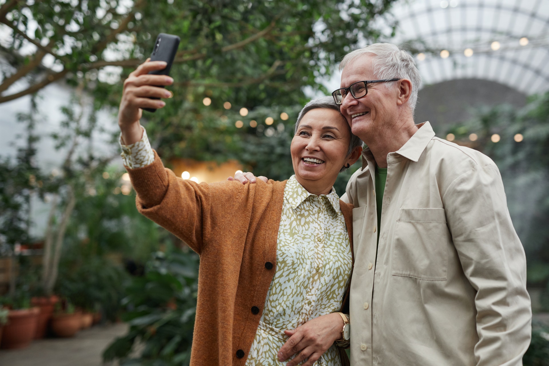 senior couple smiling while taking a sefie