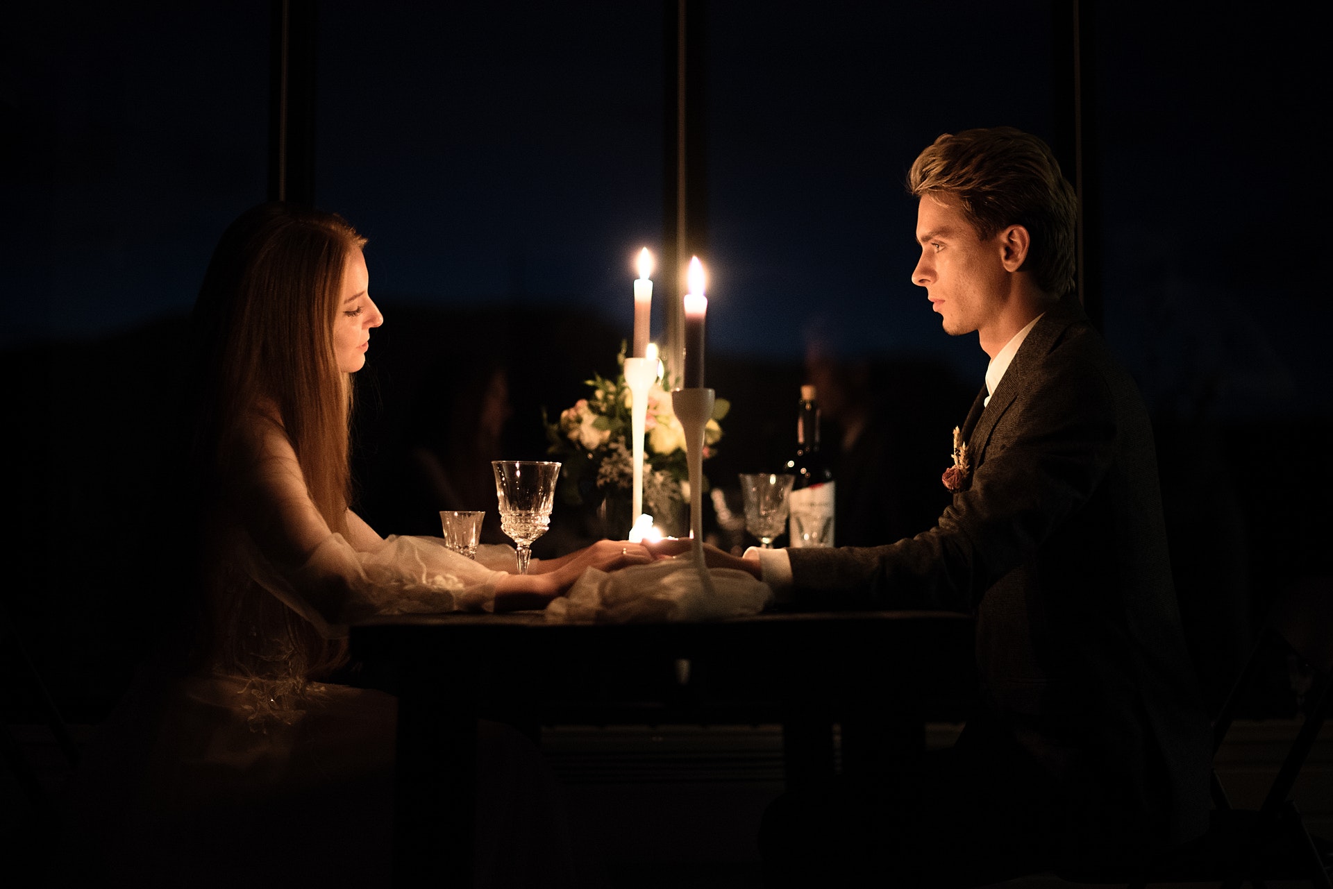 young elegant couple holding during dinner in a restaurant