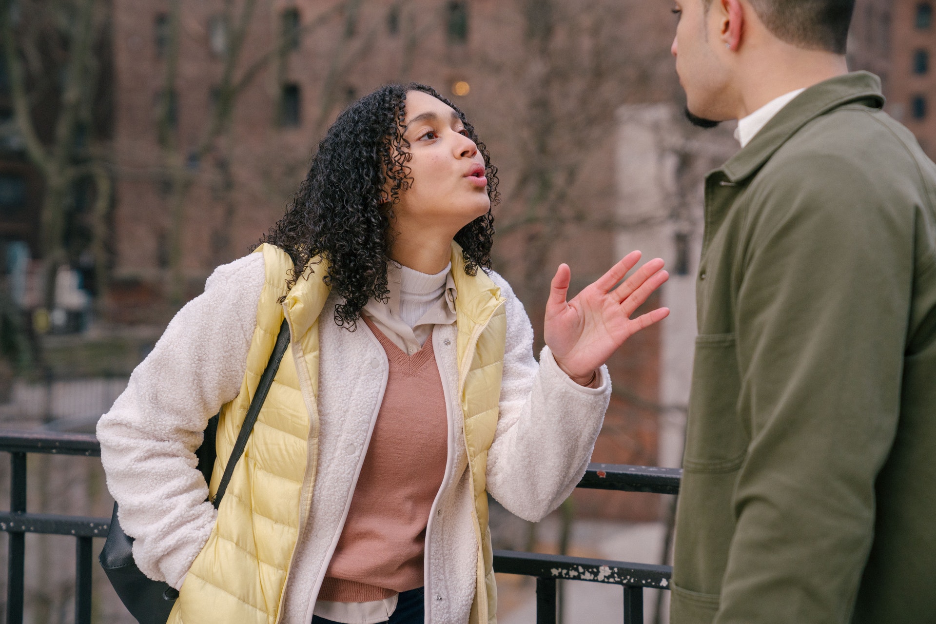 young couple arguing on street