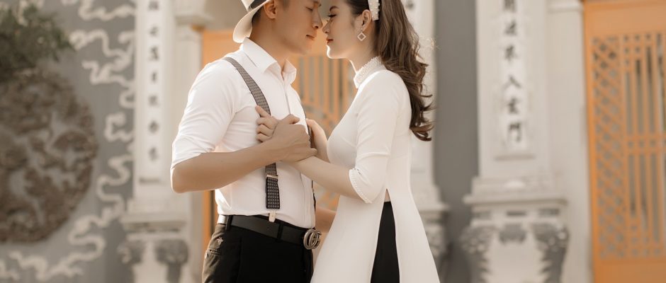 a man dating a Buddhist woman who is wearing Ao Dai
