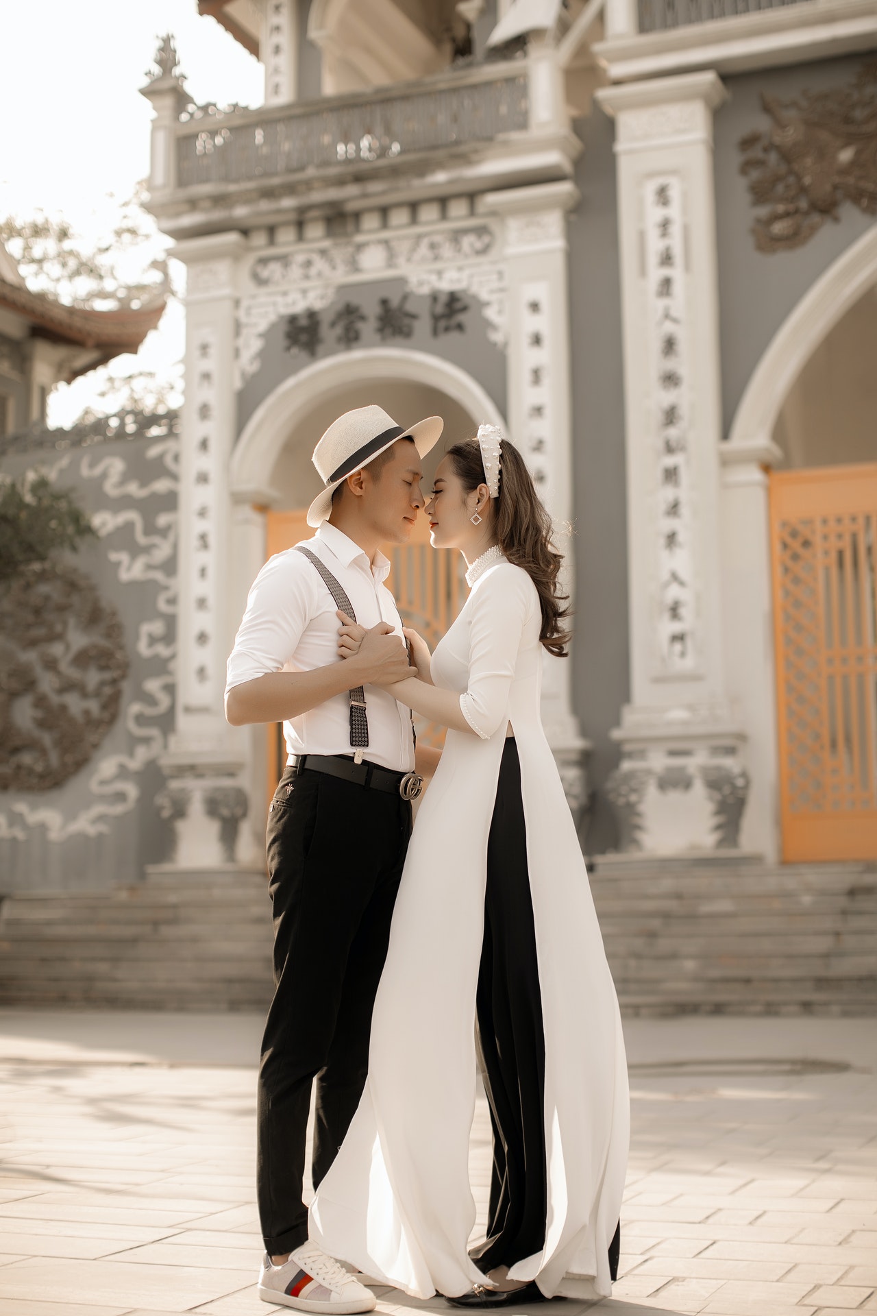 a man dating a Buddhist woman who is wearing Ao Dai