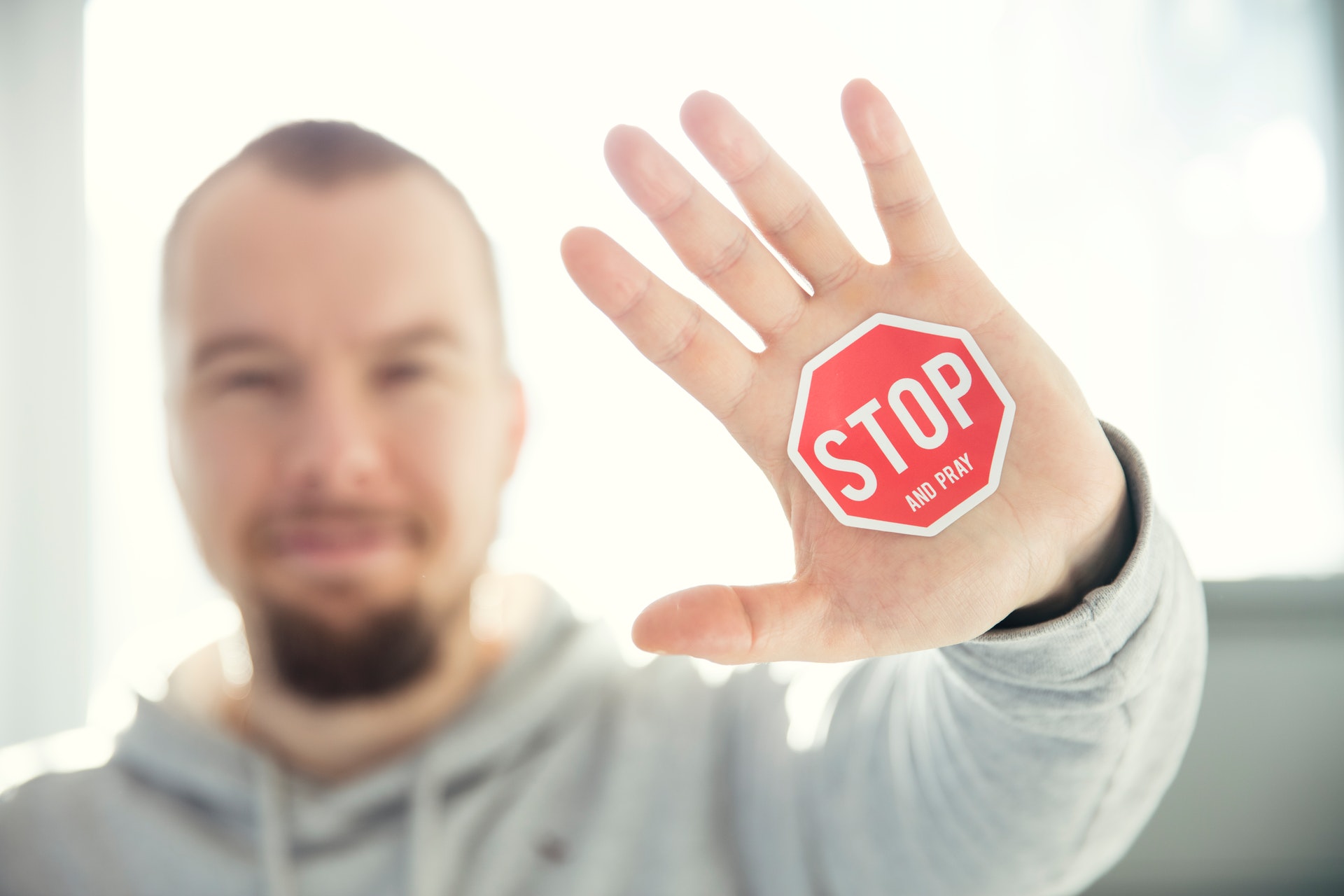 photo of a person's hand with stop sign