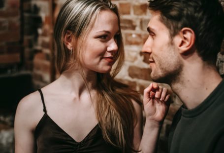 a man and a woman look passionately at each other