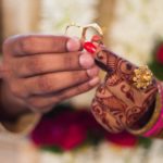 hands of a Hindu man and a woman holding wedding rings