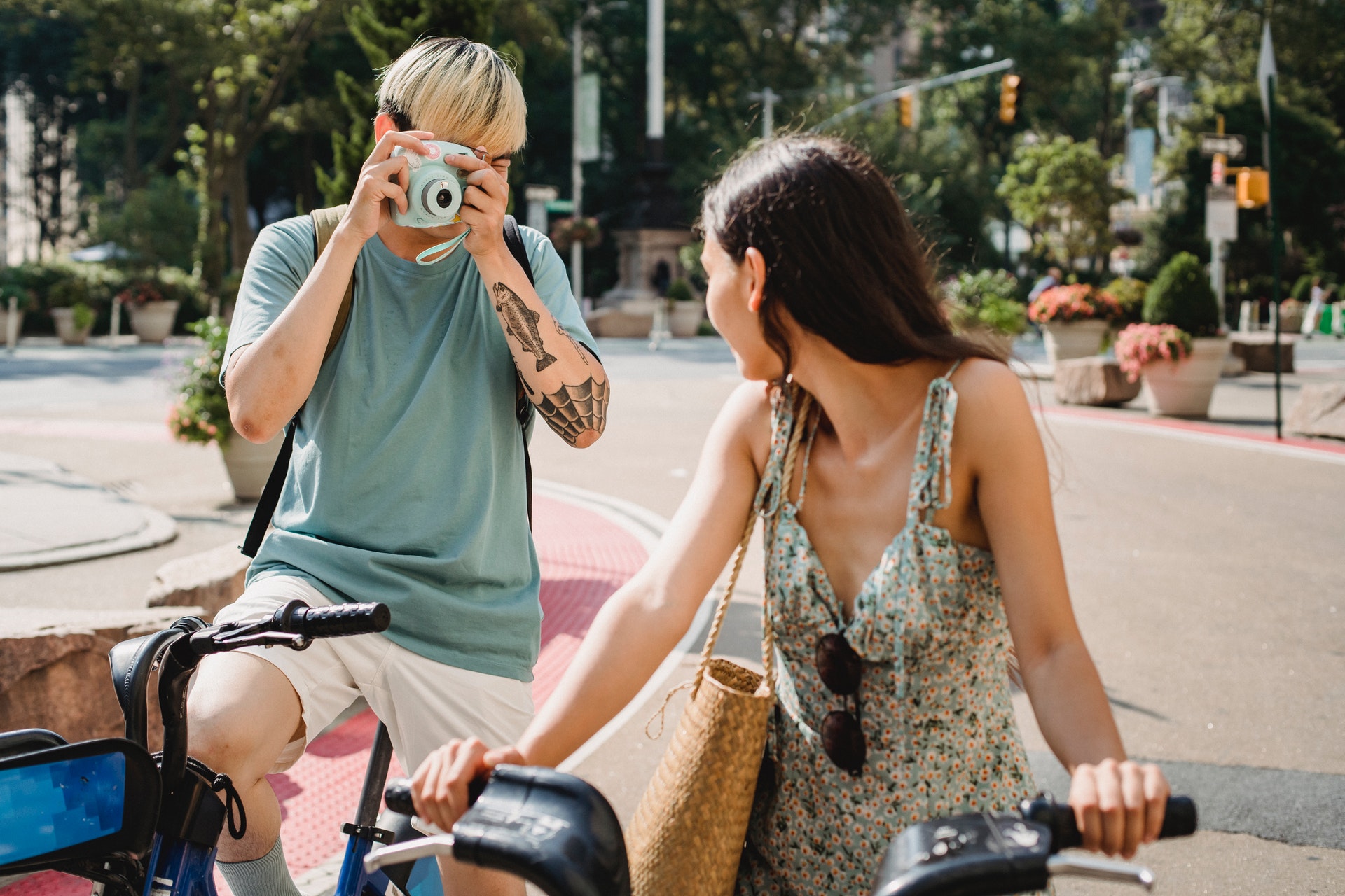 a man taking photo of a woman on bike