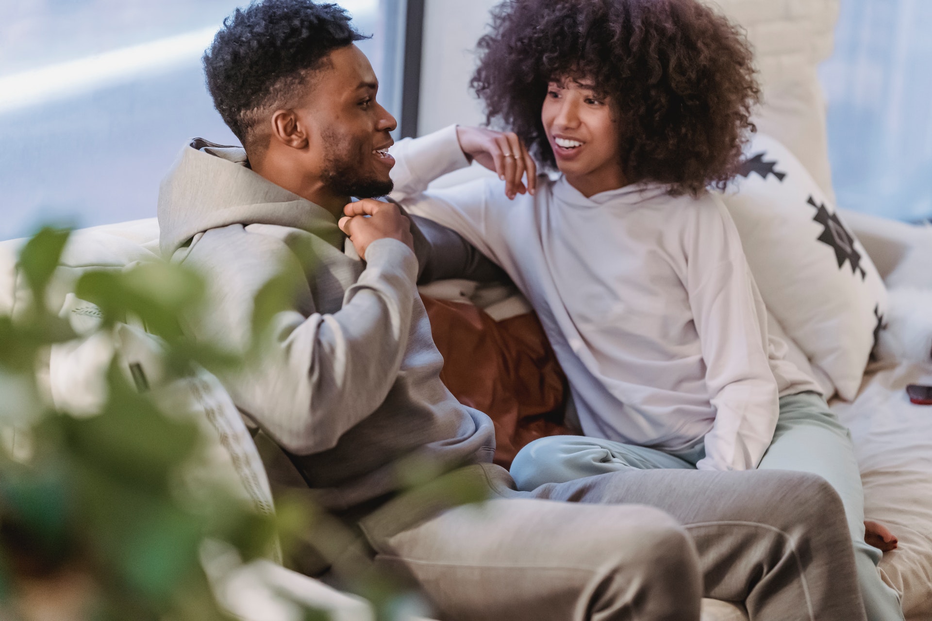 happy black couple in domestic clothes talking