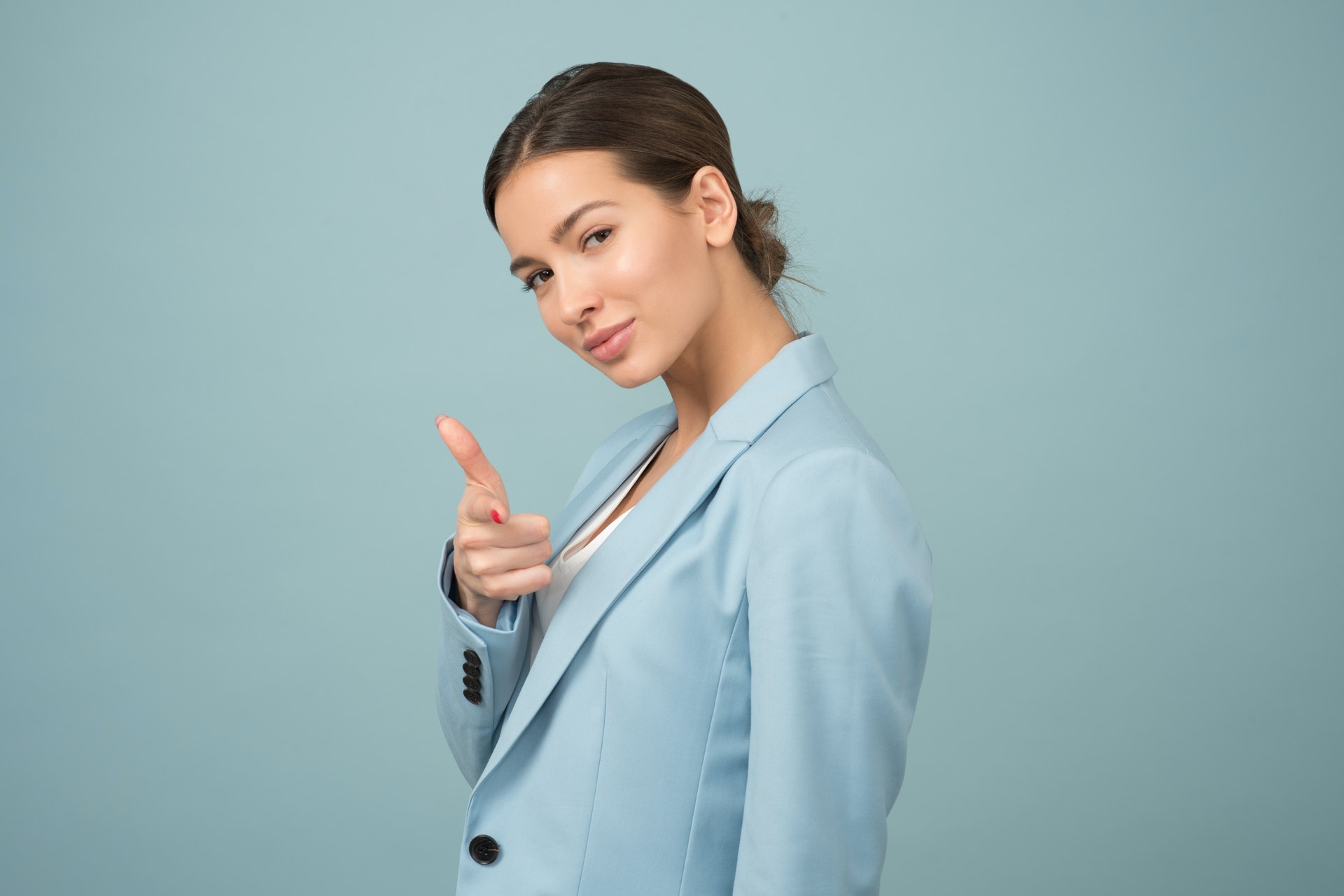 a confident woman wearing blue jacket