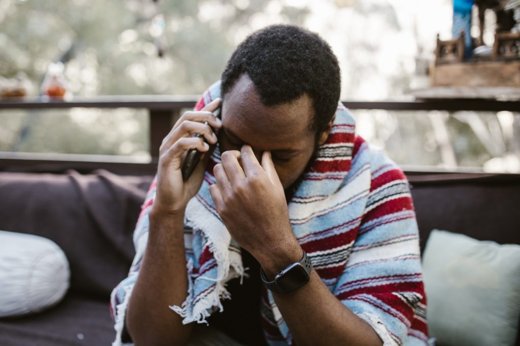 photo of a sad man talking on phone