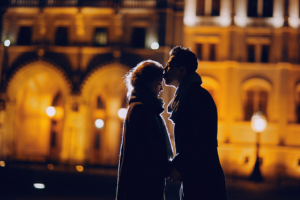 Couple kissing at night, dating in the city